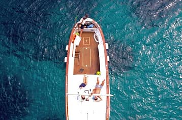 Capri in gozzo , swimming and Faraglioni Rocks